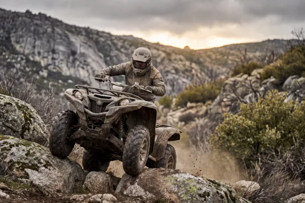 Team rider climbing a rocky hill on an ATV